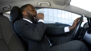 tired businessman at risk for drowsy driving crash