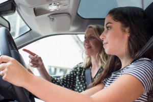 teen getting driving test tips from an instructor